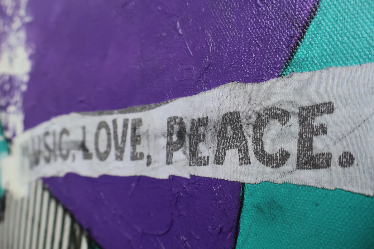 Detail of Music, Love & Peace: a paper strip reading Music, Love, Peace